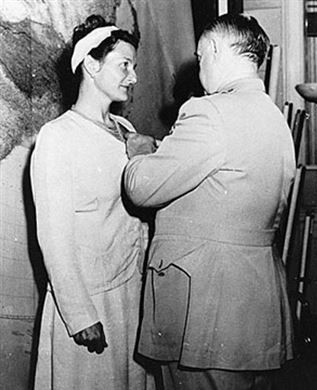 A couple of people that are standing in a room

Description automatically generated